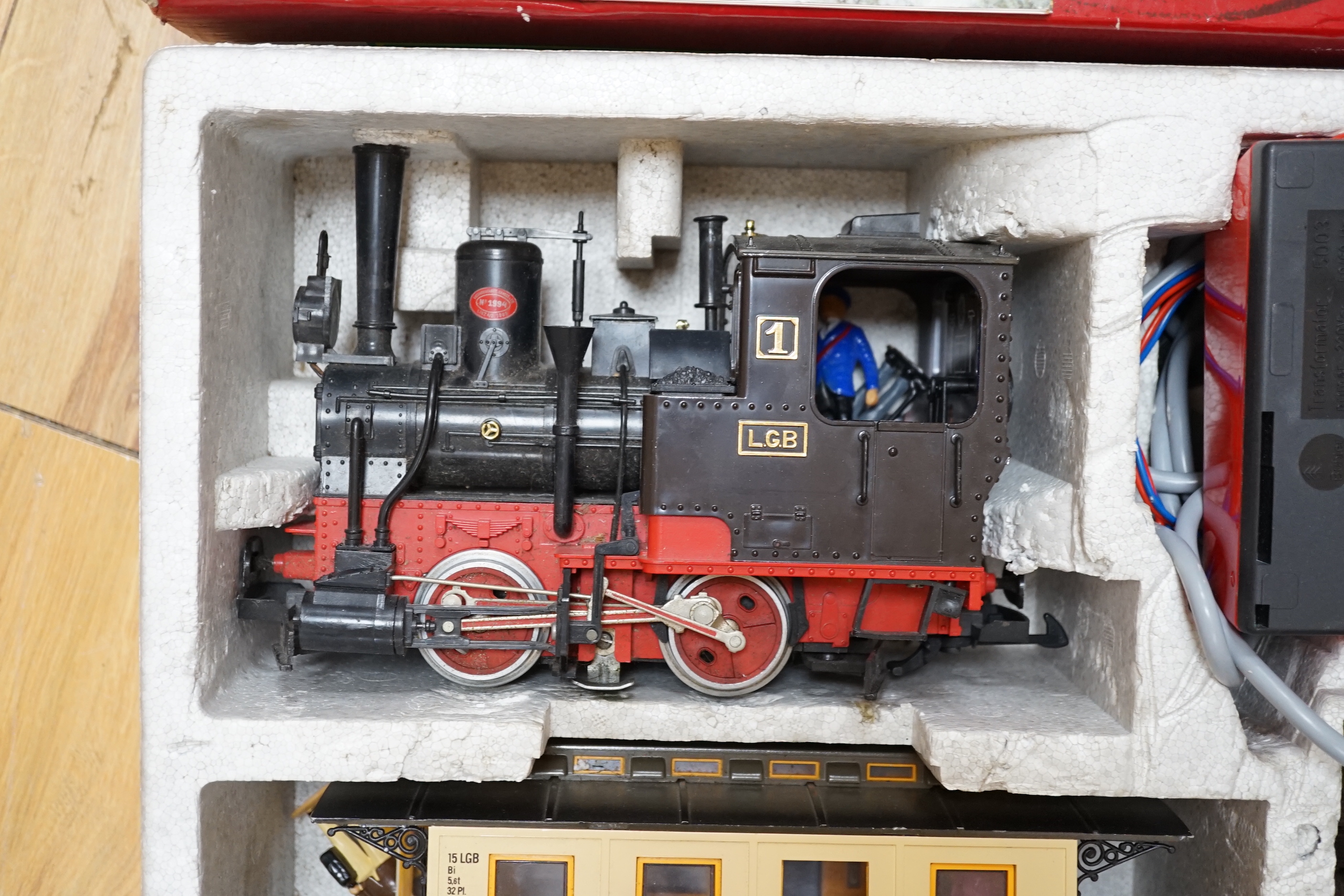 An LGB by Lehman 45mm passenger train set, comprising an 0-4-0T locomotive, two coaches, track and accessories